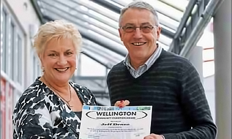 Fr Jeff Drane receives an acknowledgement of his community contribution from the local Member of Parliament, Annette King.