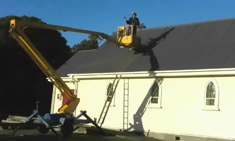 Cherry picker used to paint roof
